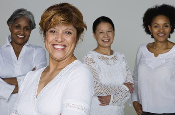 stock photo of a group of four women smiling for camera