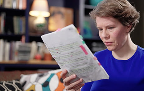 Stroke survivor, Maggie, is reading a script in a library.