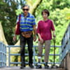 Senior couple walking through a park