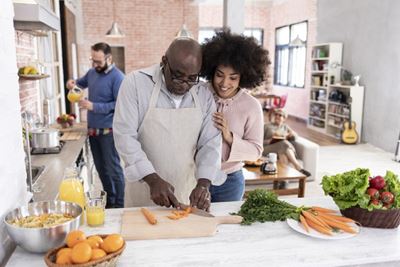 man and woman cooking in the kitchen