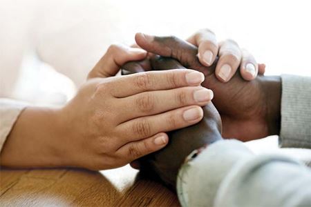 Two hands holding a male and female