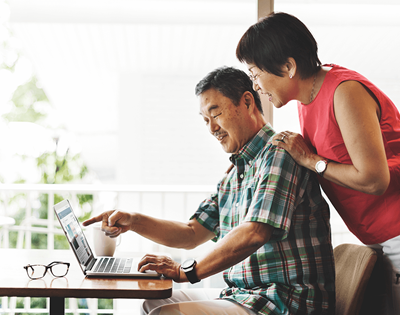 Senior couple at home on computer Senior couple at home on computer